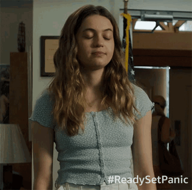 a woman with her eyes closed has the hashtag readysetpanic on her shirt