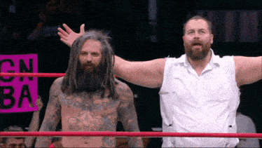 two men are in a wrestling ring with a sign that says cn ba