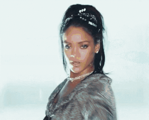 a close up of a woman wearing a fur coat and a tiara .