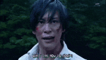 a man with blood on his face is holding a baby in his arms and screaming .