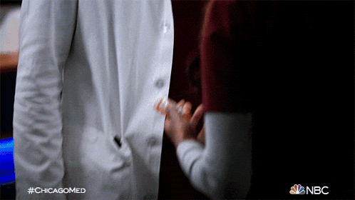 a man in a white coat is standing next to a woman in a red shirt with the hashtag #chicagomed on the bottom