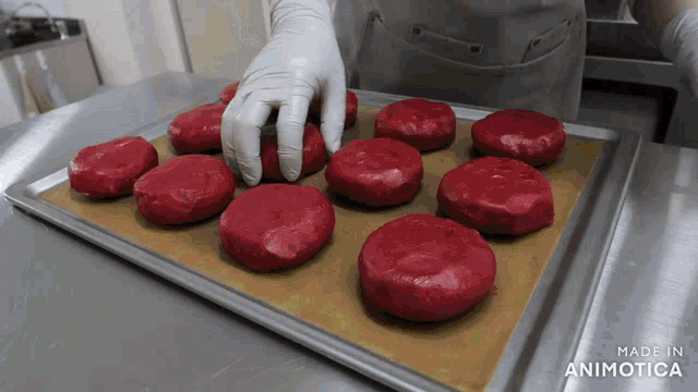 a bunch of red dough balls on a tray made in animatica