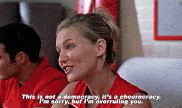 a woman in a red shirt is saying " this is not a democracy "