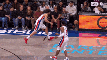 a basketball game is being played in front of a sign that says yes on it