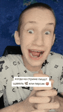 a man with a louis vuitton shirt on is smiling