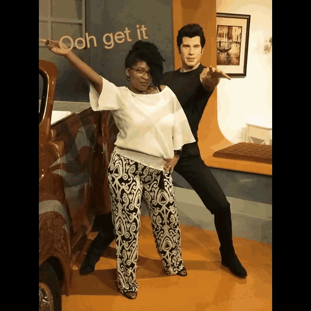 a woman standing next to a man with the words " ooh get it " behind them