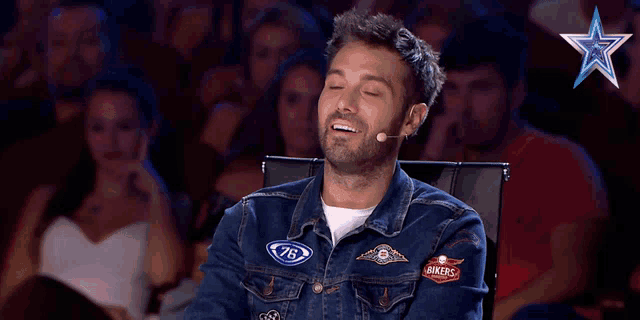 a man wearing a denim jacket that says bikers