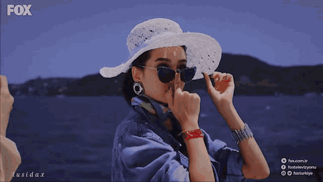 a woman wearing a hat and sunglasses is on fox