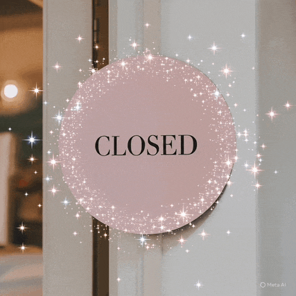 a closed sign is surrounded by sparkly stars