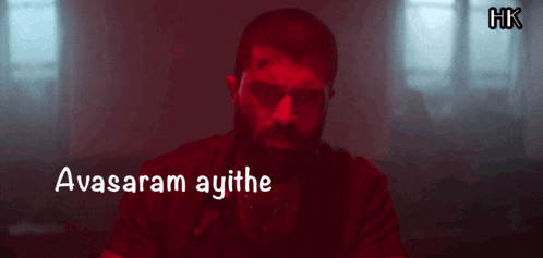 a man with a tattoo on his forehead and the words avasaram ayithe behind him