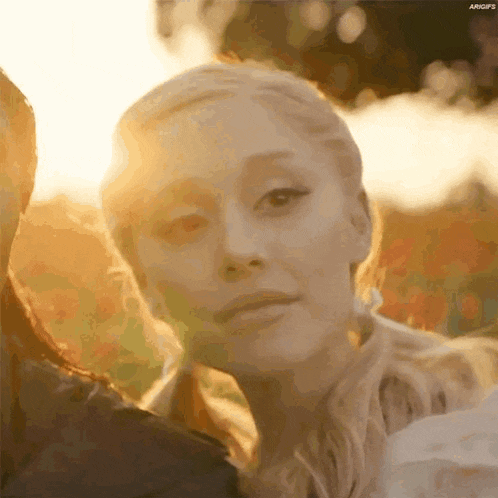 a close up of a woman 's face with the sun shining through her eyes .