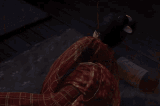 a woman in a plaid shirt is laying down