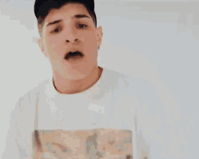 a young man is saying oh yeah with his hand outstretched