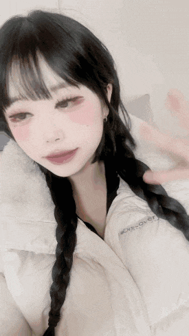 a girl with braids is wearing a white jacket with the word discovery on it