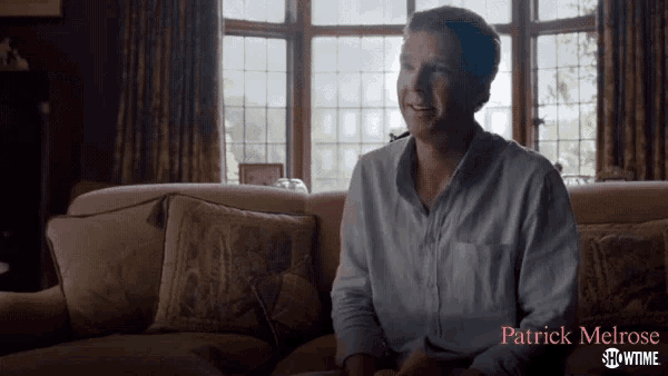 a man is sitting on a couch with showtime patrick melrose written on the bottom