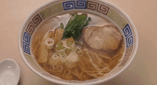 a bowl of ramen with noodles and meat in a circle with chinese symbols