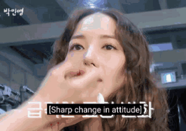 a close up of a woman 's face with the words sharp change in attitude below her