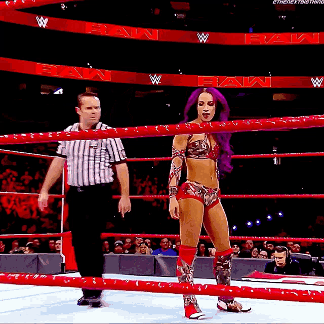 a woman with purple hair is in a wrestling ring