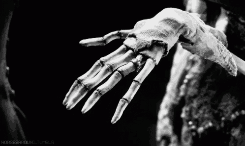 a black and white photo of a skeleton hand with the words horses around tumblr in the corner