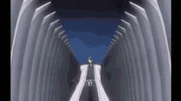 a person is standing in the middle of a tunnel .