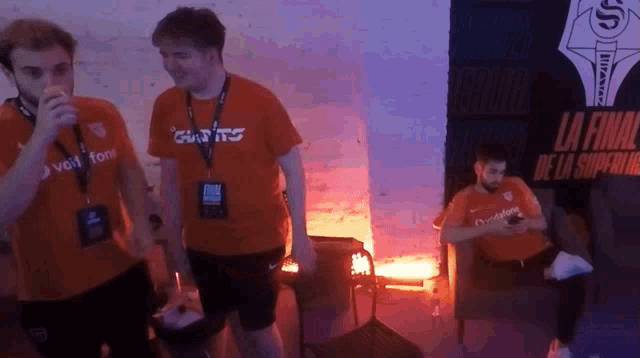 a man wearing an orange shirt that says chants on it