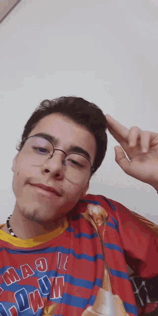 a young man wearing glasses and a shirt that says " magic "