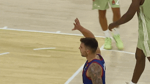 a basketball player with the number 14 on his jersey is giving a high five