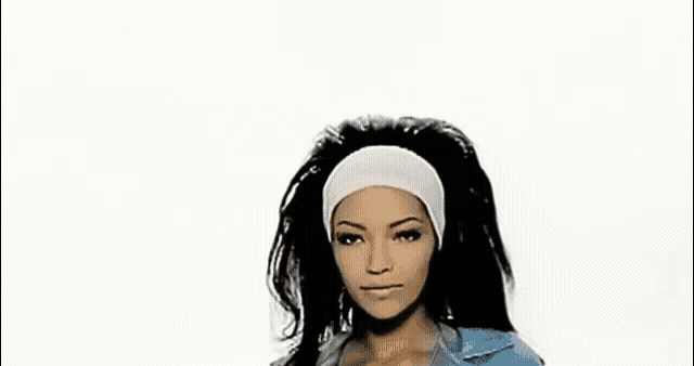 a woman with long black hair wearing a headband