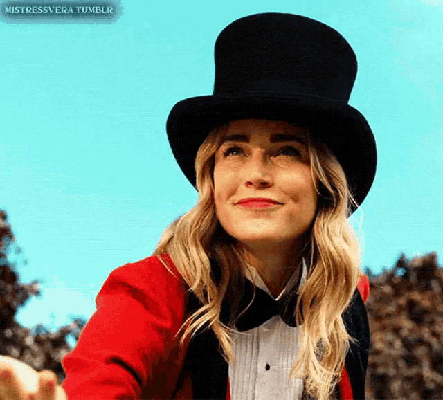 a woman wearing a top hat and a red jacket with the words mistressvera tumblr on the bottom