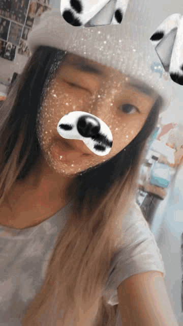 a girl wearing a white hat with a dog nose