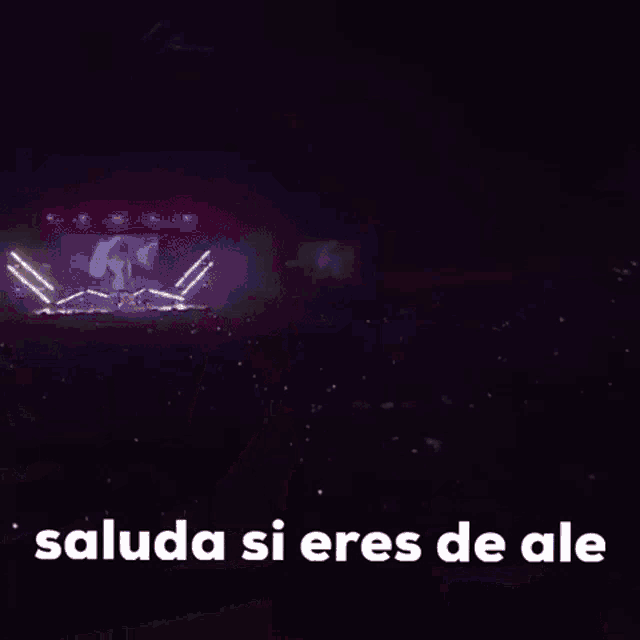 a woman in a red dress is dancing in the dark with the words saluda si eres de ale .
