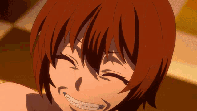 a close up of a girl with red hair making a face .