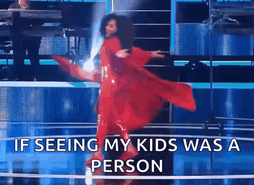 a woman in a red dress is dancing on a stage with the caption if seeing my kids was a person