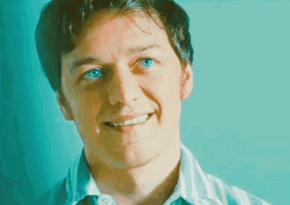 a close up of a man 's face with blue eyes smiling
