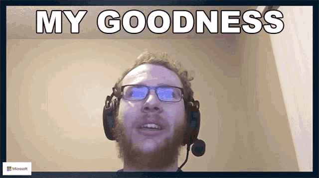 a man wearing glasses and a headset says " my goodness "