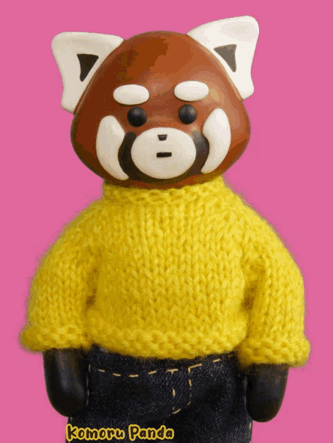 a red panda wearing a yellow sweater with komoru panda written on it