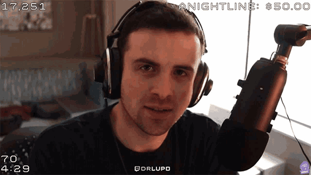 a man wearing headphones stands in front of a microphone with the words nightline $ 50.00 in the corner