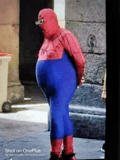a fat man in a spiderman costume is shown on a oneplus phone