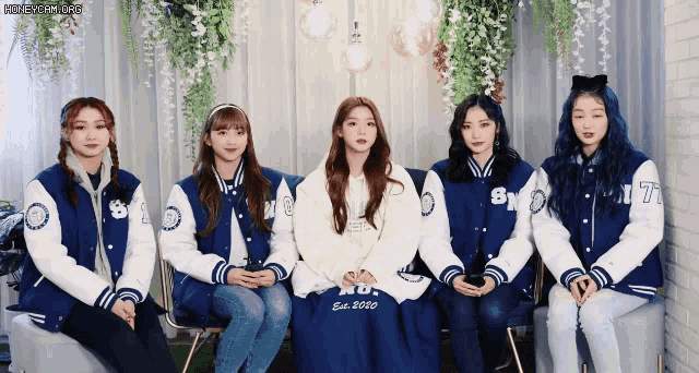 a group of girls wearing varsity jackets with the number 17 on the arm