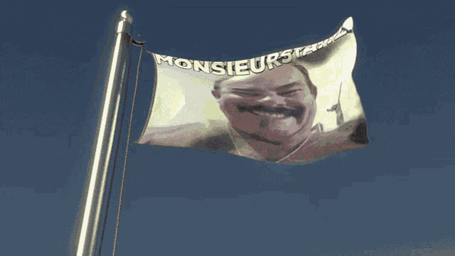 a flag with a picture of a man on it that says monsieur
