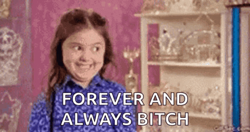 a little girl is smiling and saying `` forever and always bitch '' in front of a shelf .