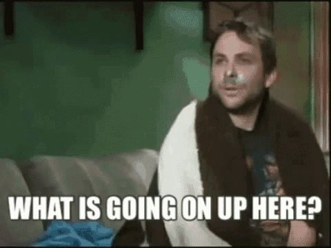 a man with a bandage on his face is sitting on a couch .