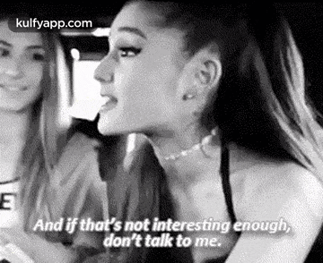 ariana grande is talking to another woman in a black and white photo while driving a car .