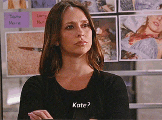 a woman wearing a black shirt with the word kate written on it