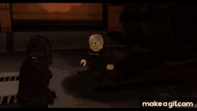 two lego star wars characters are standing next to each other and talking .