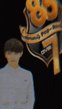 a man stands in front of a community pop logo