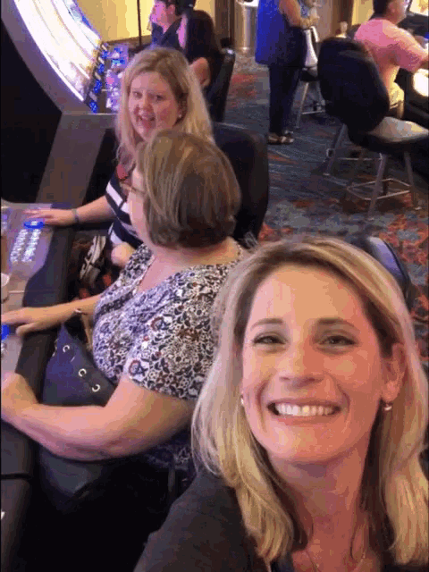 a group of women are sitting at a table and smiling