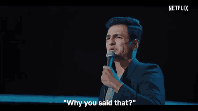 a man singing into a microphone with the words " why you said that " below him