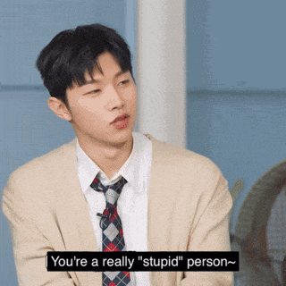 a man wearing a cardigan and tie says you 're a really " stupid " person