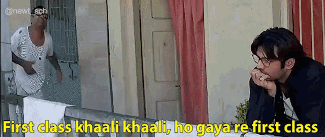 a man is sitting on a balcony talking to another man who is standing in front of him .